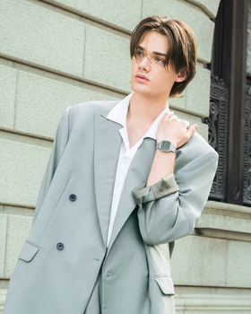 A man wearing a CASIO silver watch and a grey suit