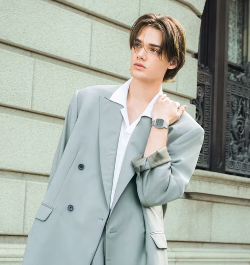 A man wearing a CASIO silver watch and a grey suit