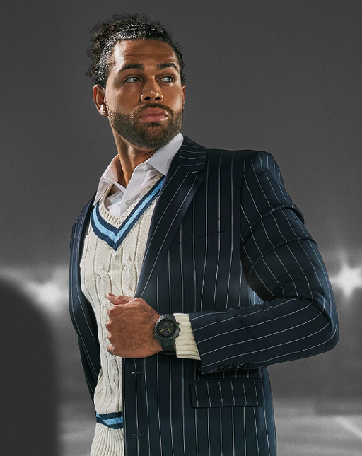 A man wearing a Garmin watch and a suit