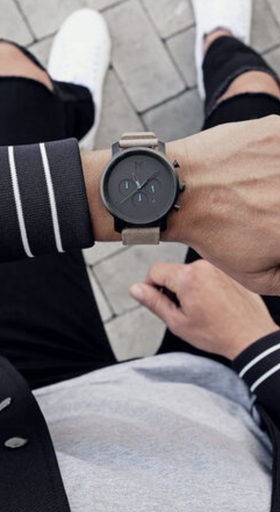 A man wearing a black MVMT watch