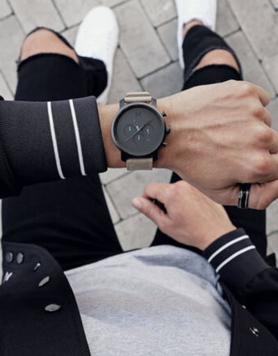 A man wearing a black MVMT watch