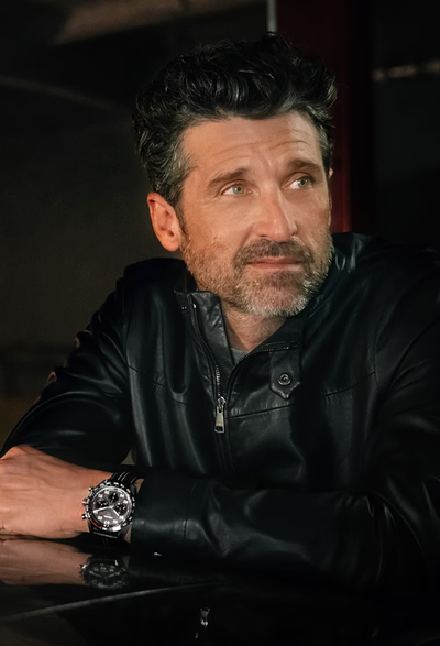 A man wearing a TAG Heuer watch with a black jacket