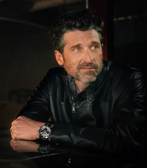 A man wearing a TAG Heuer watch with a black jacket