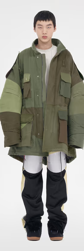 A man wearing a green We11done jacket and a white shirt