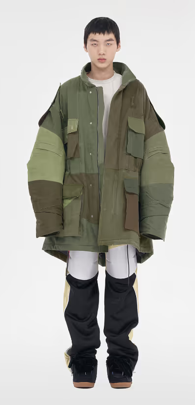 A man wearing a green We11done jacket and a white shirt