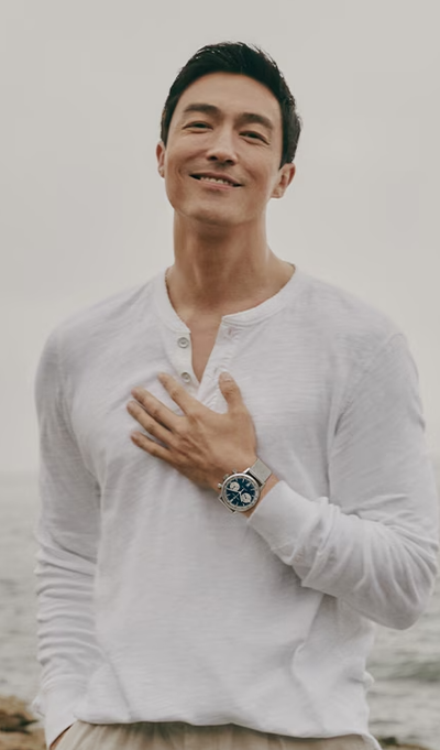 A man wearing a Hamilton watch and a white long-sleeve