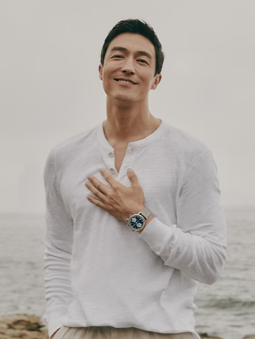 A man wearing a Hamilton watch and a white long-sleeve