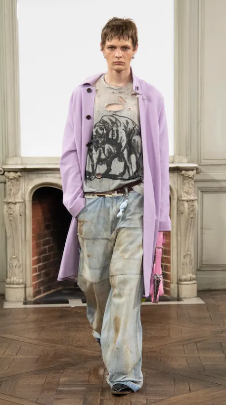 A man wearing a Sankuanz outfit in violet and jeans