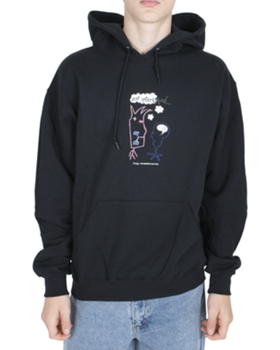 A man wearing a Frog Skateboards hoodie and blue jeans
