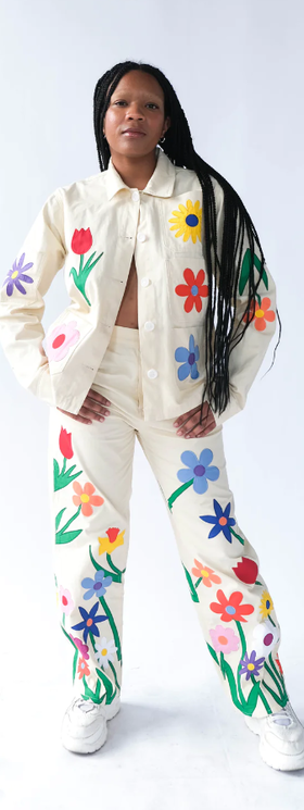 A woman wearing a Tyler McGillivary floral print white suit