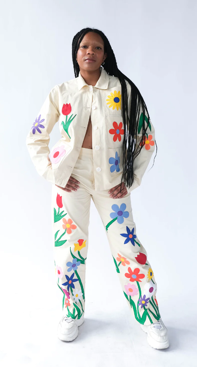 A woman wearing a Tyler McGillivary floral print white suit