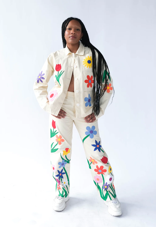 A woman wearing a Tyler McGillivary floral print white suit