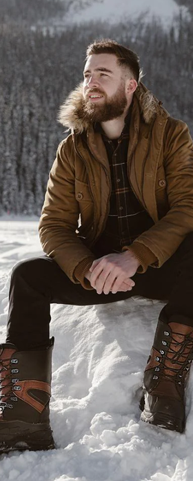 A man wearing a pair of Baffin Boots in the snow