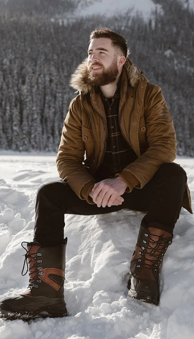 A man wearing a pair of Baffin Boots in the snow