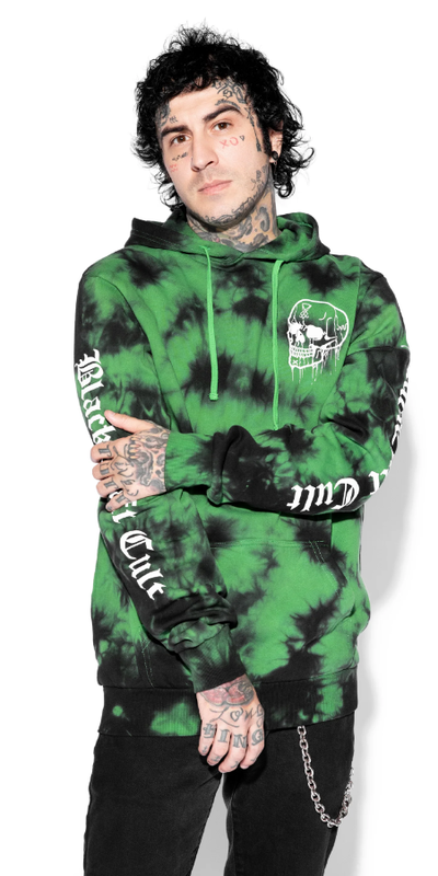 A man wearing an acid-green Black Craft Cult hoodie with black pants