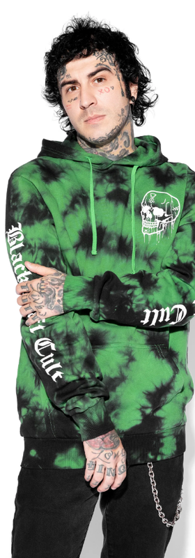A man wearing an acid-green Black Craft Cult hoodie with black pants