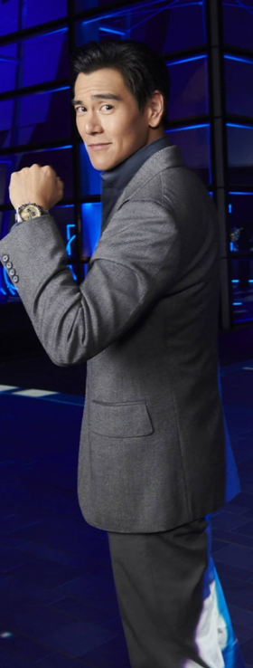 A man wearing a Longines watch and a suit