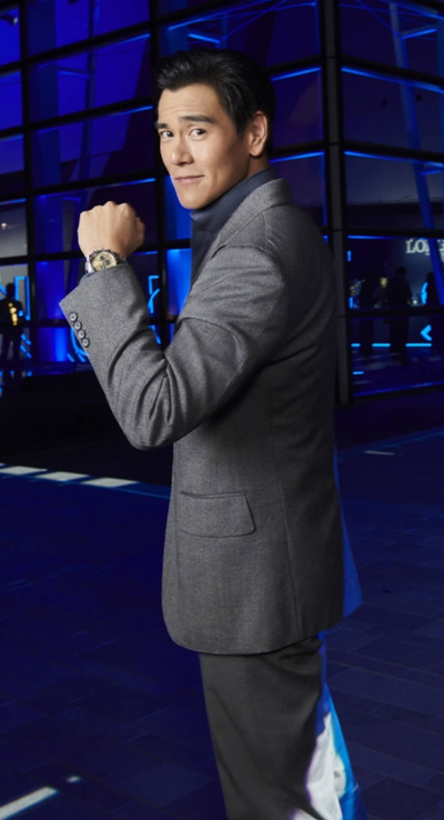 A man wearing a Longines watch and a suit