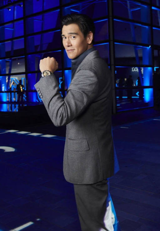 A man wearing a Longines watch and a suit