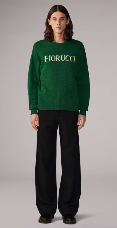 A woman wearing a white Fiorucci logo t-shirt with tight-fitting jeans
