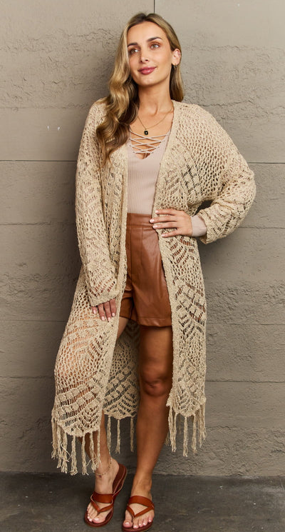 A woman wearing a boho Elise Stories cream and white outfit