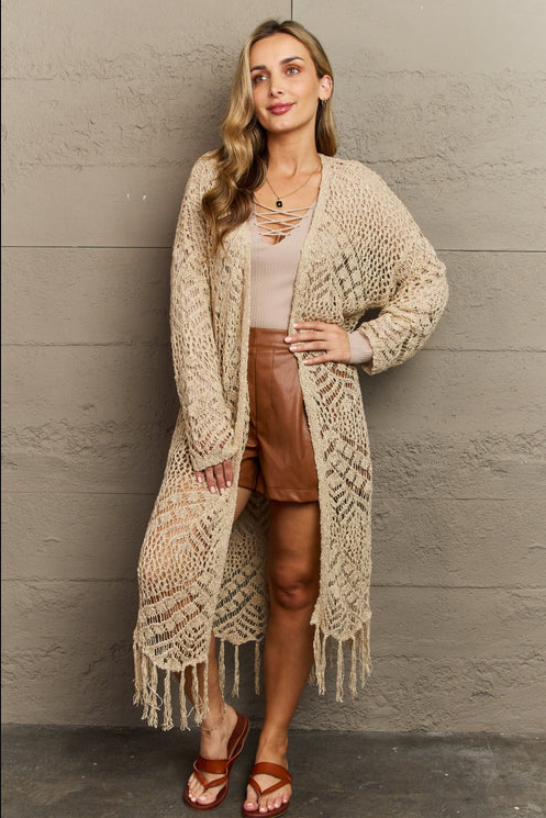 A woman wearing a boho Elise Stories cream and white outfit
