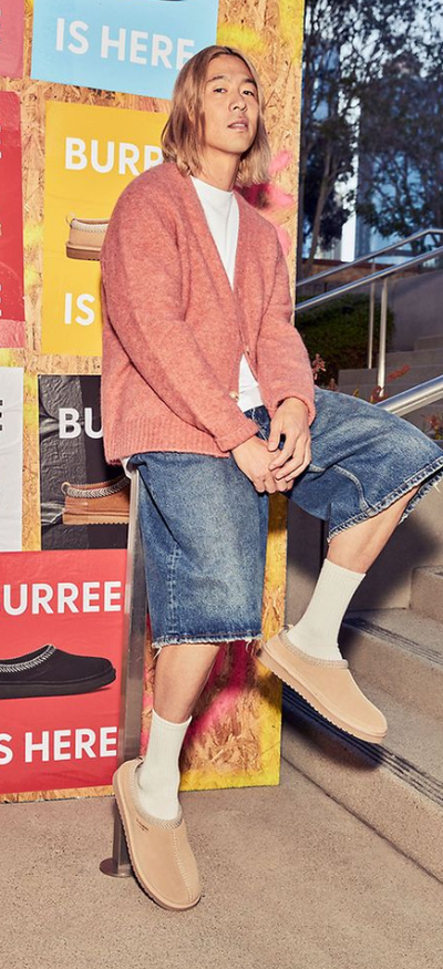 A man wearing a pair Koolaburra shoes in cream