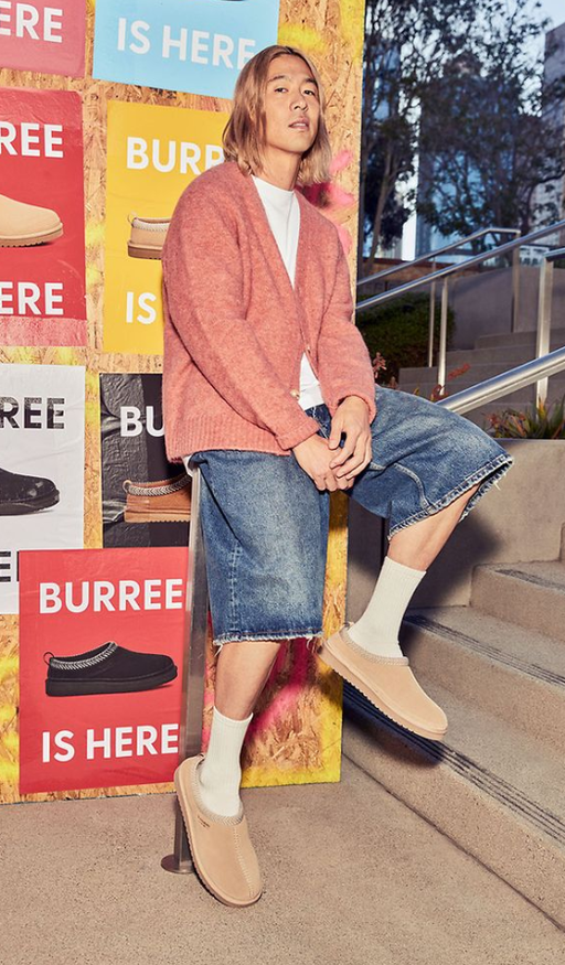 A man wearing a pair Koolaburra shoes in cream