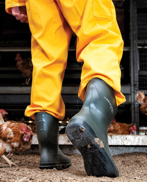 A man wearing a pair of Dunlop Boots with a yellow rain suit