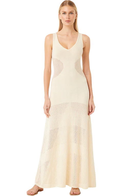 A woman wearing a bohemian cream Misa dress