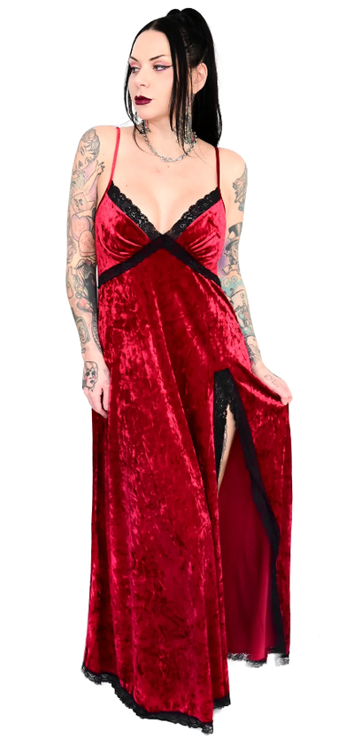 A woman wearing a gothic red FoxBlood Clothing dress