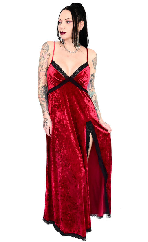 A woman wearing a gothic red FoxBlood Clothing dress