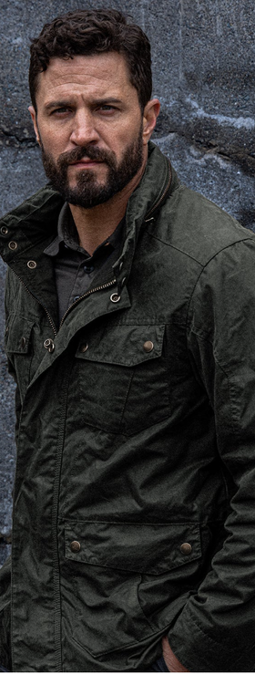 A man wearing a Triple Aught Design green jacket