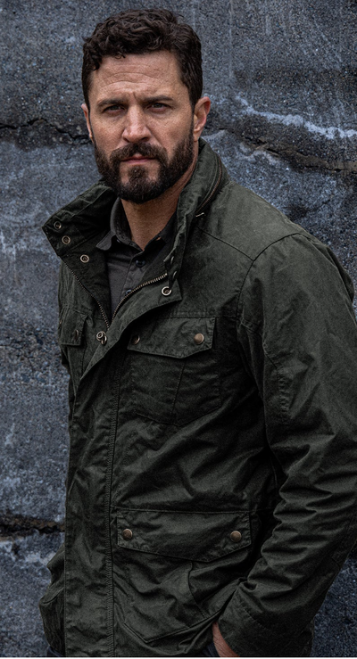 A man wearing a Triple Aught Design green jacket