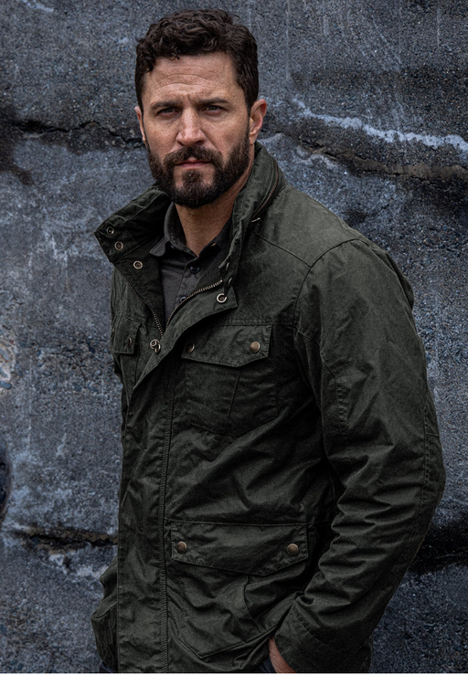 A man wearing a Triple Aught Design green jacket