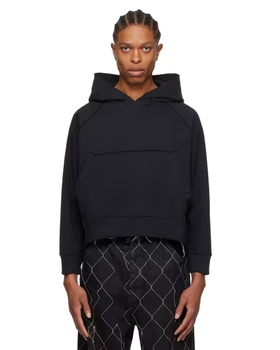A man wearing a AIREI black fitted hoodie