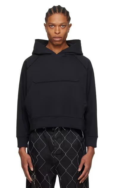 A man wearing a AIREI black fitted hoodie