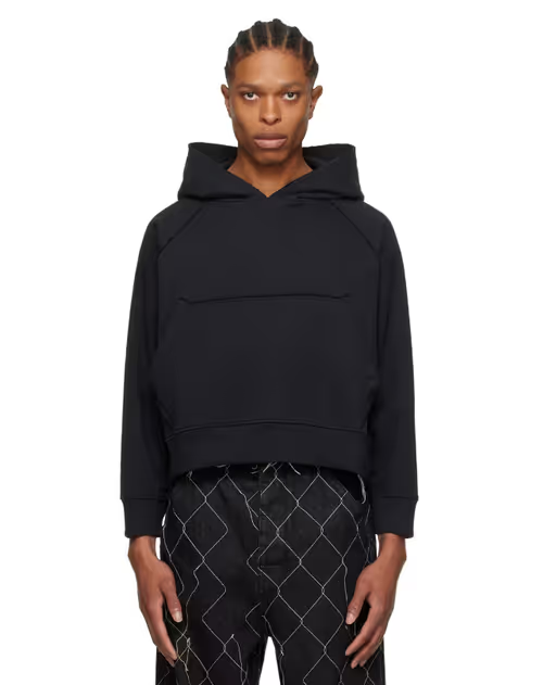 A man wearing a AIREI black fitted hoodie