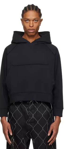 A man wearing a AIREI black fitted hoodie