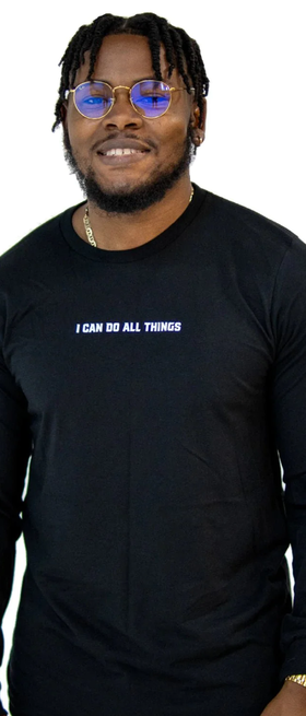 A man wearing a Walk In Faith long sleeve black t-shirt