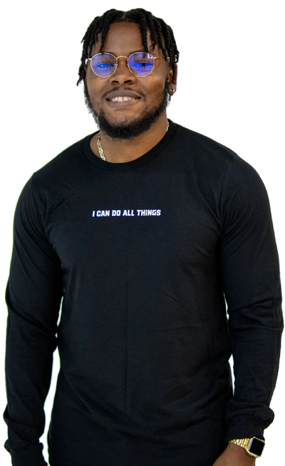 A man wearing a Walk In Faith long sleeve black t-shirt