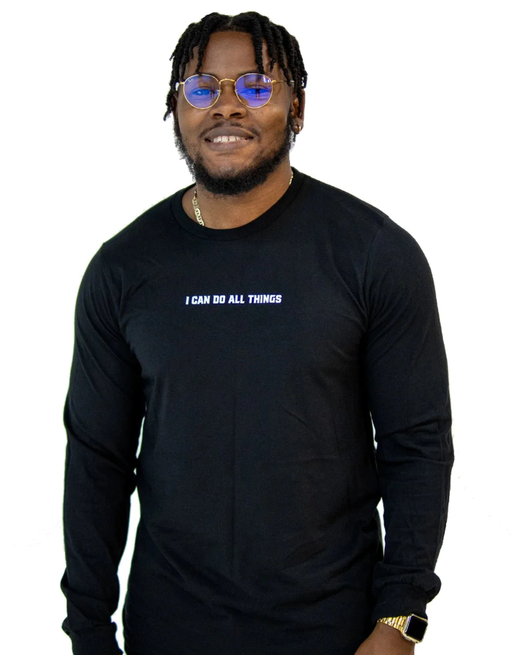 A man wearing a Walk In Faith long sleeve black t-shirt