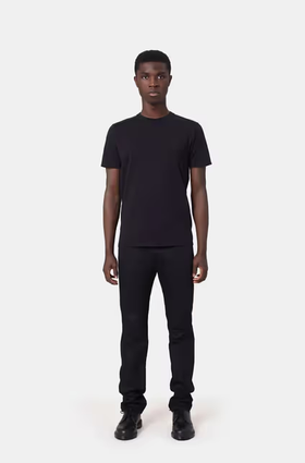 A man wearing a Colorful Standard deep black t-shirt