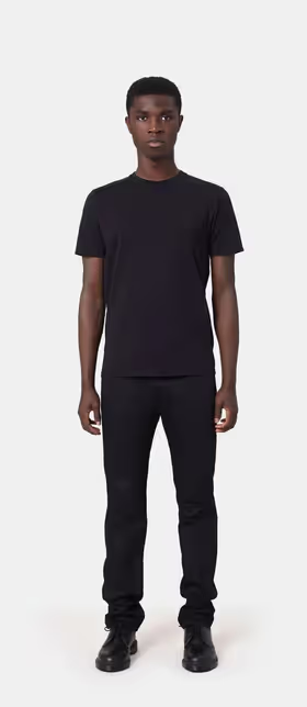 A man wearing a Colorful Standard deep black t-shirt