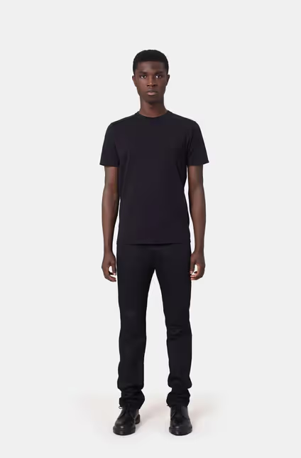 A man wearing a Colorful Standard deep black t-shirt