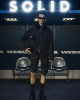 A man wearing a Cutler and Gross Glasses black sunglass