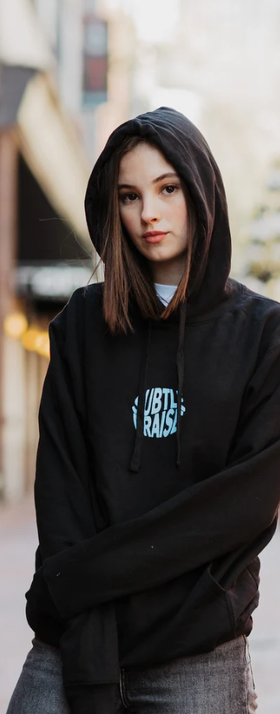 A woman wearing a God The Father black hoodie