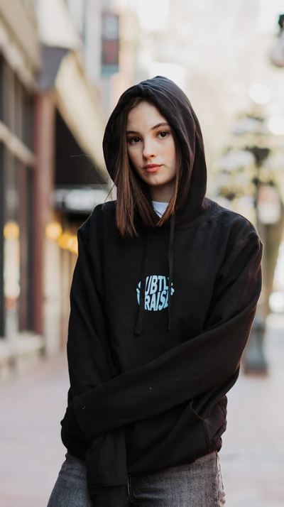 A woman wearing a God The Father black hoodie