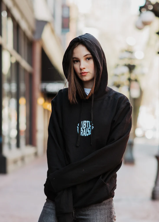A woman wearing a God The Father black hoodie