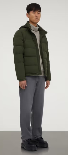 A man wearing a ASPESI green nylon quilted jacket